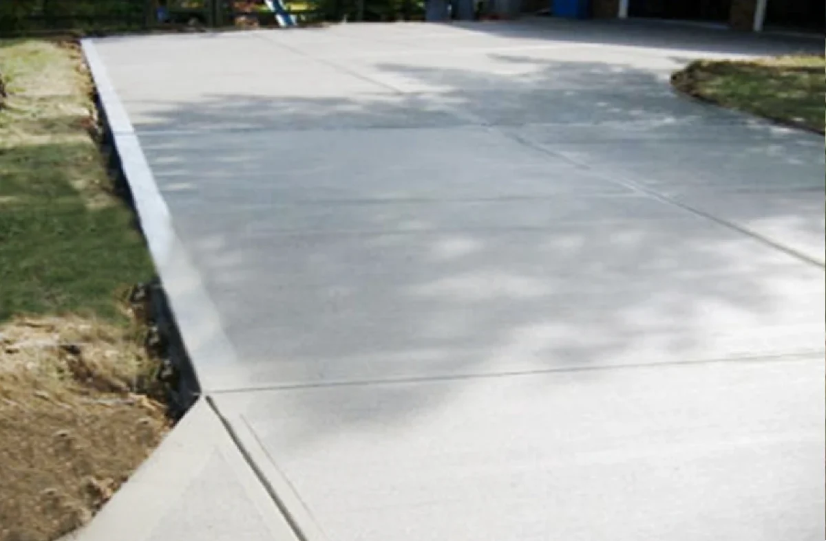 Concrete surface driveway with clear markings, showcasing durability and potential for extended lifespan with nano coating solutions from London Home Service.